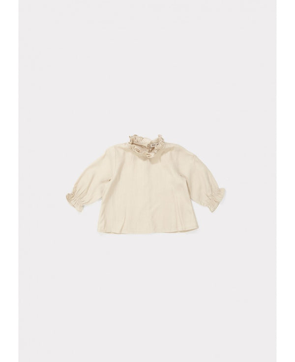 Blusa bebé bege, gola redonda com folho na gola e no punho, botões na parte de trás, silhueta fluída